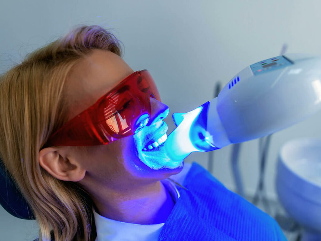 woman receiving professional teeth whitening