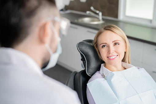 smiling woman looking at dentist