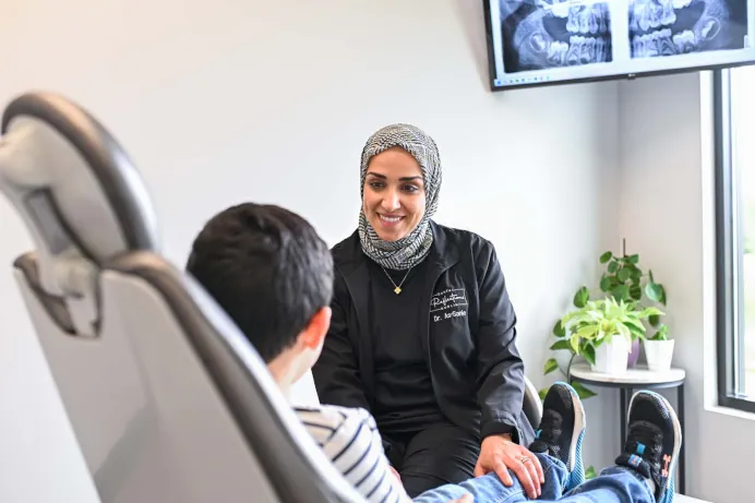 Dr. Rudi As-Sanie, dentist in Dublin, OH, with a patient at Dental Reflections Dublin